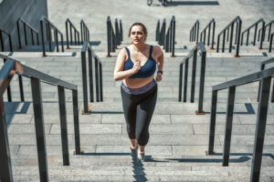 overweight beginner running up stairs