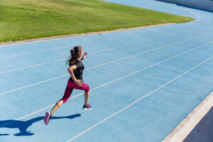 Runner doing a running workout on an athletic track.