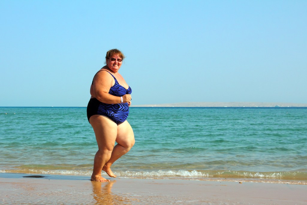 plus size runner workout on the beach