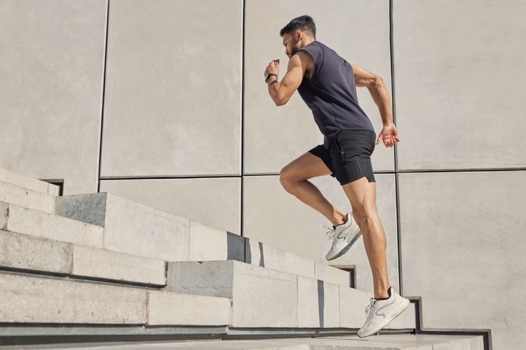 runner going up stairs for hill sprint workout