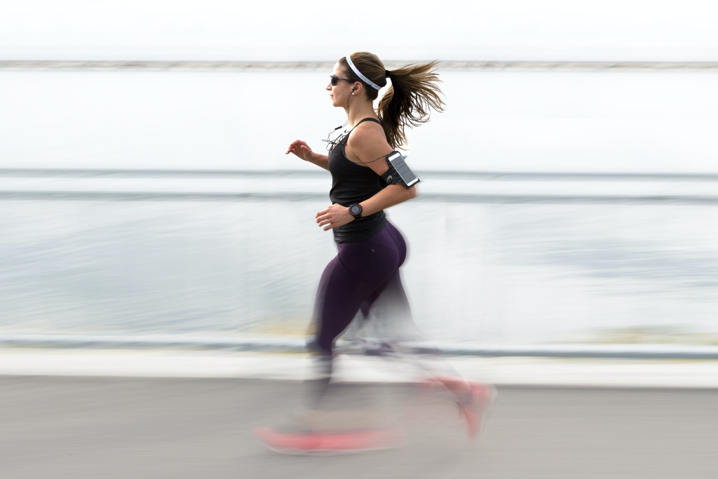 woman running with bright jogging shoes